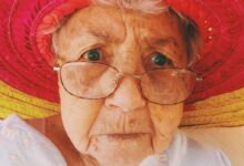 woman in white top wearing eyeglasses
