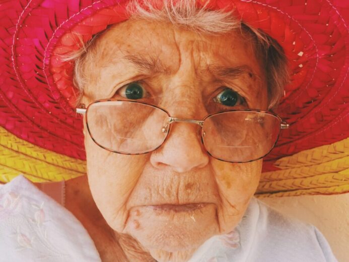 woman in white top wearing eyeglasses