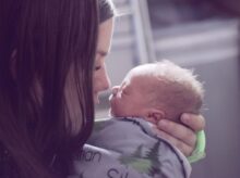 woman kissing baby