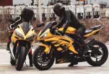 man in black helmet riding yellow sports bike during daytime