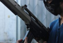 person holding assault rifle