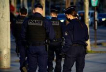 2 police men in police uniform standing on road during daytime