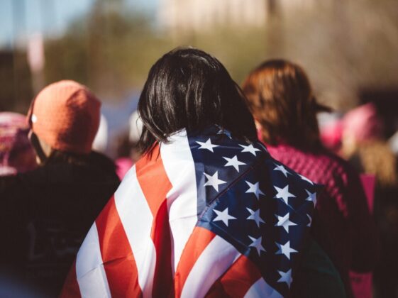 woman with US American flag on her shoulders