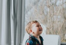 boy sitting near glass wall