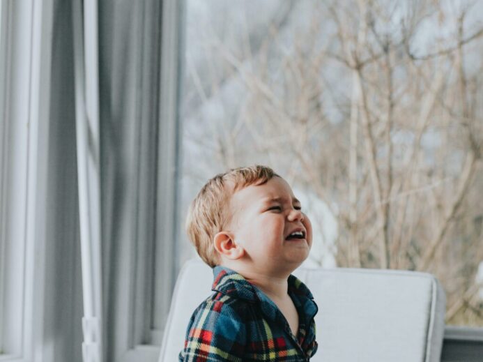 boy sitting near glass wall