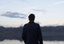 man in black top under cloudy sky