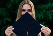 woman covering her face with blue paper