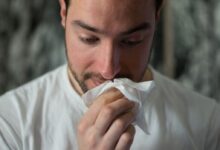 man wiping mouse with tissue paper