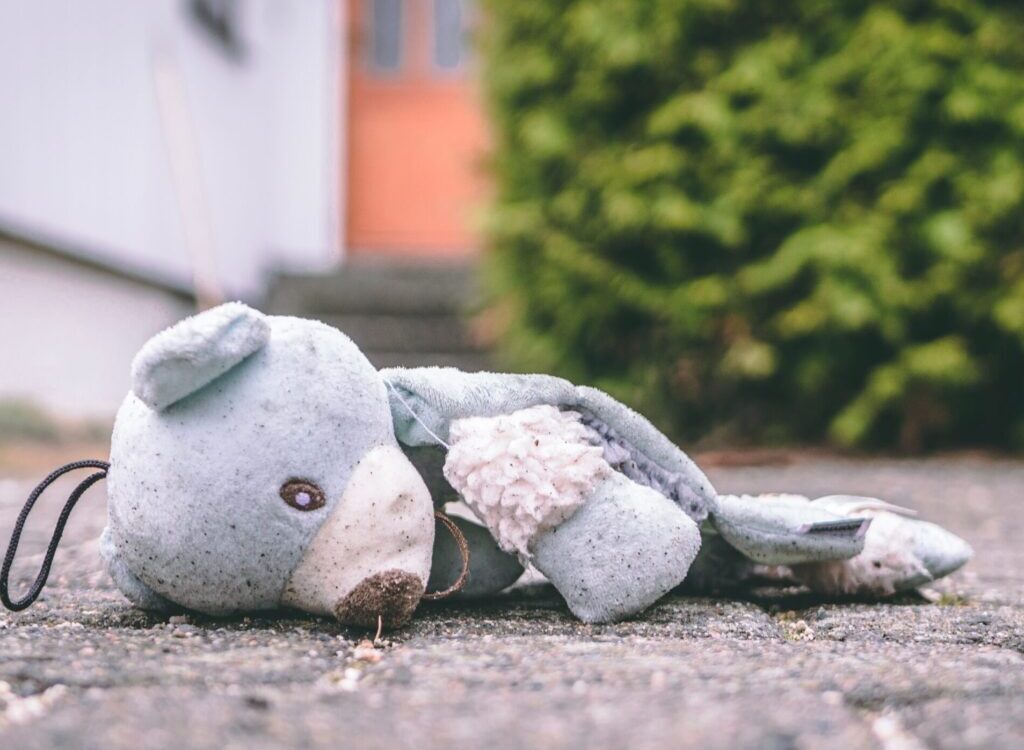photo of bear plush toy on pavement