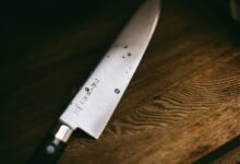 gray knife on brown wooden surface