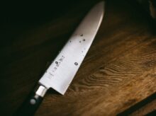 gray knife on brown wooden surface