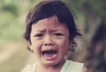 selective focus photography of girl crying