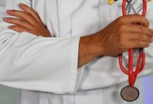 doctor holding red stethoscope