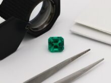 green glass bottle on white table