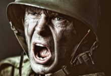 man in green zip up jacket wearing black helmet