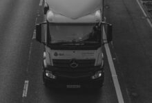 grayscale photo of car on road