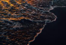 ocean waves crashing on shore during daytime