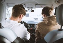 two men sitting inside vehicle