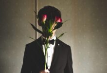 man holding red rose