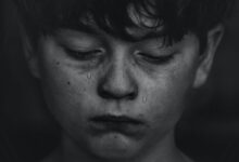 a boy crying tears for his loss
