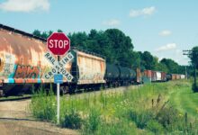 red and white train on rail tracks during daytime
