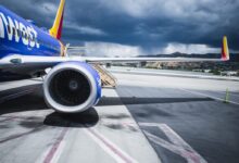passenger plane on airport under gray cloudy sky