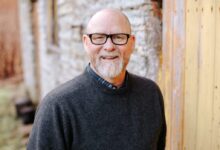 man in black crew neck sweater wearing black framed eyeglasses