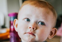 selective focus photography of child's face