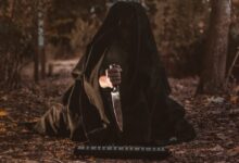 person holding knife with black textile cover