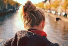 woman standing in front of body of water