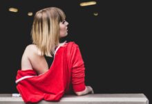 woman leaning back on railing