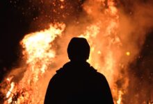 person standing in front of fire