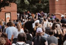people gathering near brown brick building during daytime