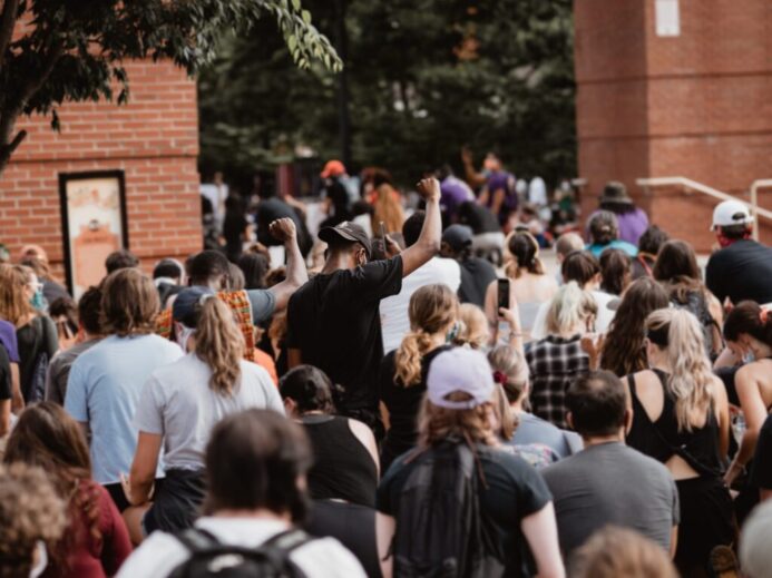 people gathering near brown brick building during daytime
