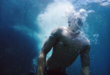man swimming under water