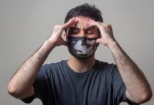 man in black crew neck t-shirt wearing black and white mask