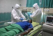 man in white medical scrub lying on hospital bed
