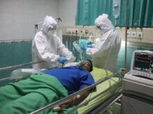 man in white medical scrub lying on hospital bed