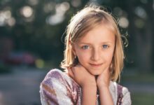 selective focus photography of girl in sequined white-and-pink stripe shirt