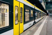 yellow and white train on train station during daytime