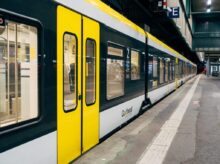 yellow and white train on train station during daytime