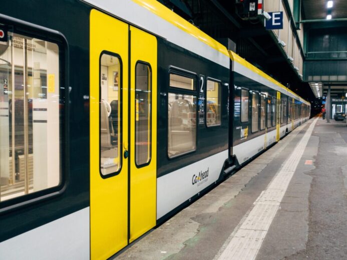 yellow and white train on train station during daytime