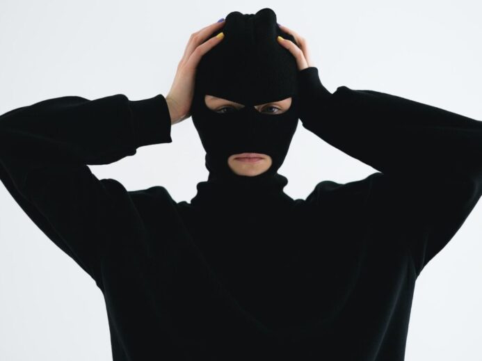 Close-Up Shot of a Person Wearing a Robber Mask