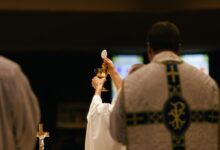 man in white robe holding white smartphone