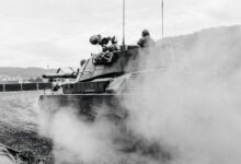 grayscale photo of soldiers on battle tank