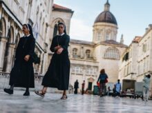 two nun walking in front of cathedral