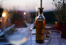printed bottle near clear glass wine cup close-up photography