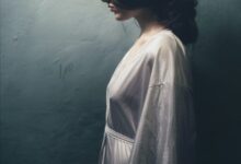 painting of woman in white long-sleeved dress