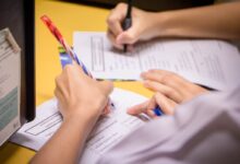 person writing on white paper