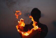 person holding fire at night